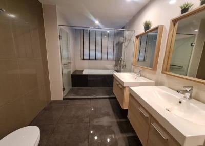 Modern bathroom with glass shower enclosure and double vanity