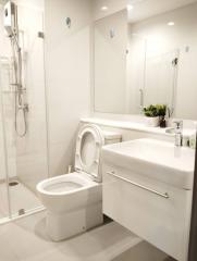 Modern bathroom with glass shower and white fixtures