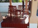 Wooden patio furniture set under a covered outdoor area