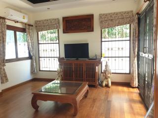 Spacious living room with hardwood floors and natural light