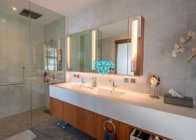 Modern bathroom with double vanity and glass shower