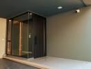 Modern house entrance with large glass door and exterior lighting