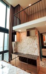 Modern bedroom with loft bed and stylish stone wall accent