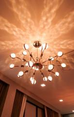 Contemporary living room with a modern chandelier and warm lighting