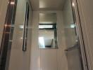 Modern residential elevator interior with mirrored walls