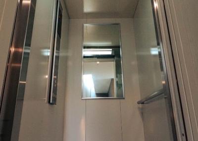 Modern residential elevator interior with mirrored walls