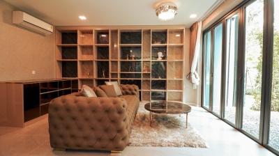 Spacious living room with built-in bookcase and large window
