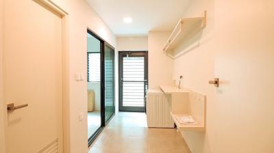 Bright hallway interior with tiled floor leading to a room with a sliding glass door