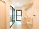 Bright hallway interior with tiled floor leading to a room with a sliding glass door