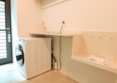 Modern laundry room with washing machine and built-in storage