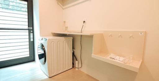 Modern laundry room with washing machine and built-in storage