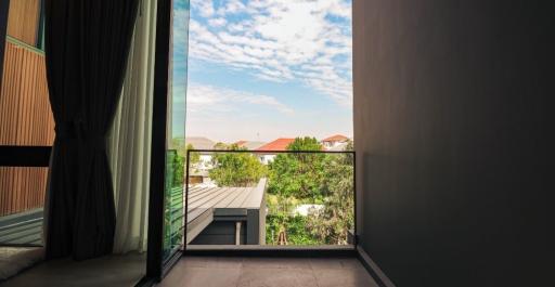 View from the balcony with clear sky and neighborhood landscape