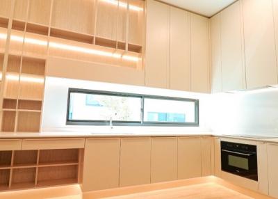 Modern kitchen interior with wooden cabinets and built-in appliances