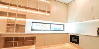 Modern kitchen interior with wooden cabinets and built-in appliances