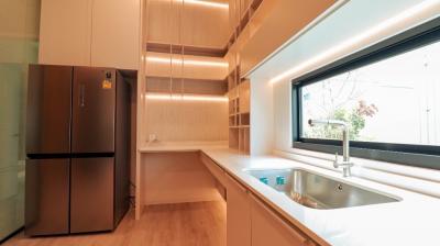 Modern kitchen with wooden cabinets and stainless steel appliances