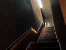 Modern staircase with wood finishes and ambient lighting