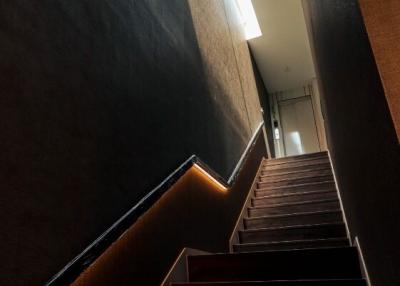 Modern staircase with wood finishes and ambient lighting