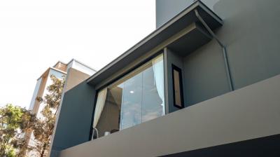 Modern building facade featuring large windows and a balcony