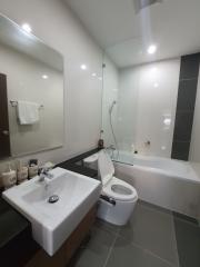 Modern bathroom with glass shower enclosure and white fixtures