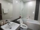 Modern bathroom with glass shower enclosure and white fixtures