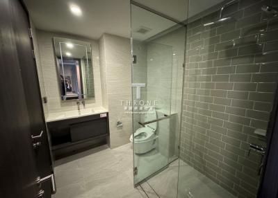 Modern bathroom with glass shower enclosure and large mirror