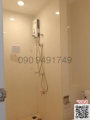 bathroom with wall-mounted water heater and shower