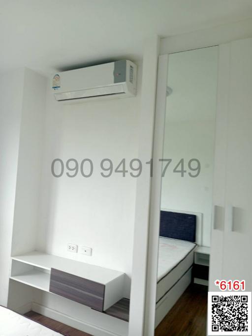 Compact bedroom with air conditioning and built-in shelves