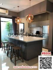 Modern kitchen with bar stools and pendant lighting