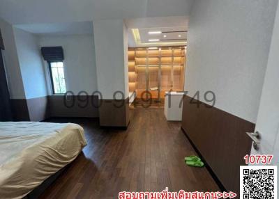 Spacious bedroom with hardwood floors and built-in wardrobes