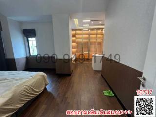 Spacious bedroom with hardwood floors and built-in wardrobes