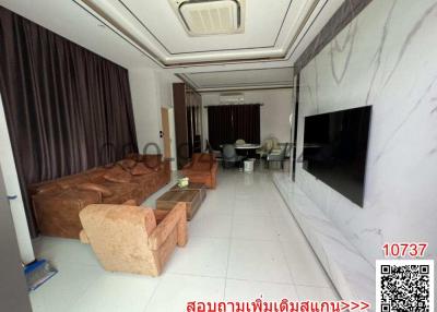 Spacious living room with marble flooring and plush sofas
