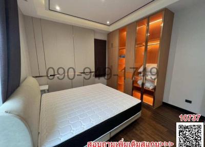 Modern bedroom interior with king-sized bed and built-in closet