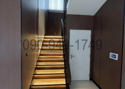Modern staircase with wooden steps and LED strip lighting