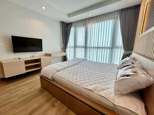 Spacious bedroom with large bed and modern furnishings