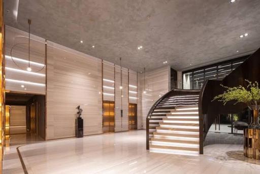 Spacious and modern lobby with elegant stairs and artistic decor