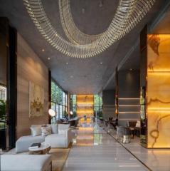 Luxurious open-concept lobby with modern furniture and chandelier