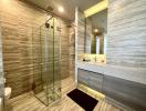 Modern bathroom with glass-enclosed shower and marble tiles