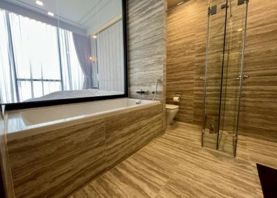 Modern bathroom with bathtub and glass-enclosed shower