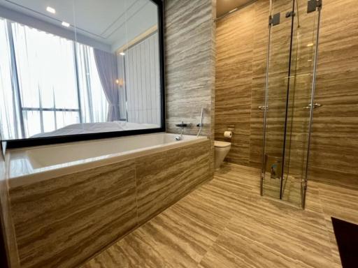 Modern bathroom with bathtub and glass-enclosed shower