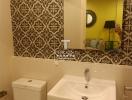 Cozy bathroom interior with patterned wallpaper and modern fixtures