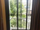 Bright balcony with a view of greenery and protective railing