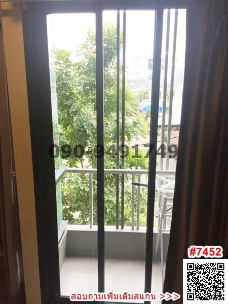 Bright balcony with a view of greenery and protective railing