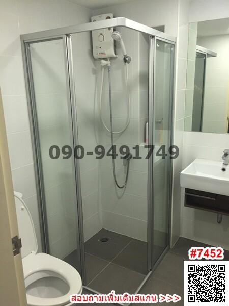 Modern bathroom with glass shower enclosure and white basin