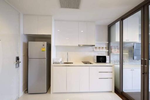 Modern kitchen with white cabinetry and stainless steel appliances