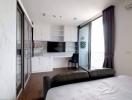 Modern bedroom with an integrated kitchenette and balcony access