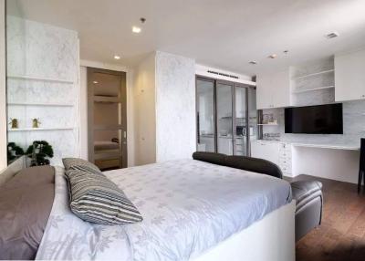 Modern bedroom with queen-size bed, built-in wardrobes, and ensuite bathroom