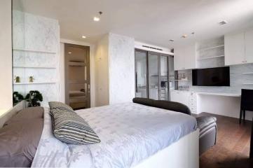 Modern bedroom with queen-size bed, built-in wardrobes, and ensuite bathroom