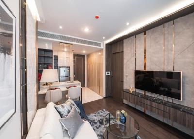 Modern and well-lit living room space with open-plan kitchen