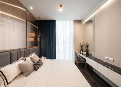 Modern bedroom with neutral tones and ample lighting