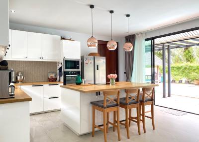 Modern kitchen with central island and pendant lighting